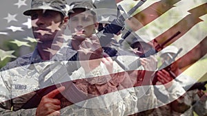 US soldiers holding weapons with US flag waving foreground