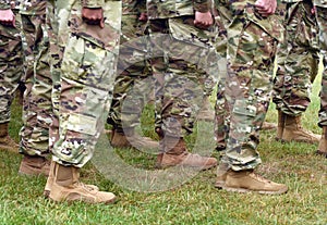 US soldiers legs in green camouflage military uniform. US troops