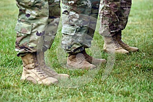 US soldiers legs in green camouflage military uniform. US troops