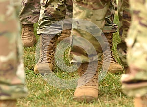 US soldiers legs in green camouflage military uniform. US troops