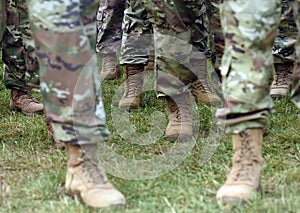 US soldiers legs in green camouflage military uniform. US troops