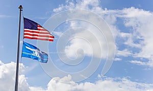 US and Tavares flag against the blue bright sky photo