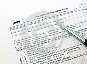 US tax form 1065 with a silver pen