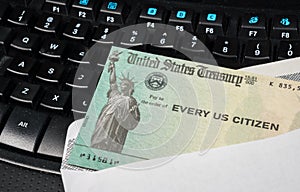 Illustration of the federal stimulus payment check from the IRS on keyboard photo