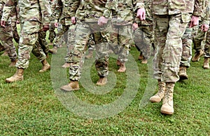 US troops. Soldiers marching on green grass. US Army