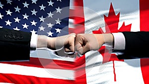 US vs Canada conflict, international relations crisis, fists on flag background