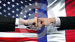 US vs France conflict, international relations crisis, fists on flag background