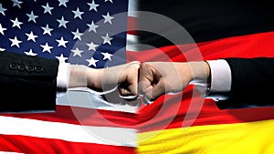 US vs Germany conflict, international relations crisis, fists on flag background