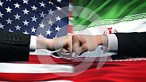 US vs Iran conflict, international relations crisis, fists on flag background