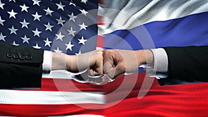 US vs Russia conflict, international relations crisis, fists on flag background