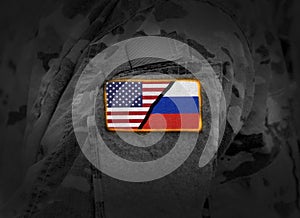 US vs Russia. Flag of United States and Russia at military uniform (collage)