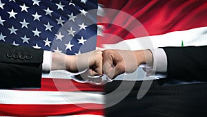 US vs Syria conflict, international relations crisis, fists on flag background
