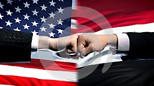 US vs Syria conflict, international relations crisis, fists on flag background