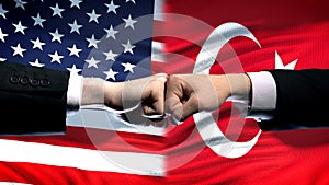 US vs Turkey conflict, international relations crisis, fists on flag background