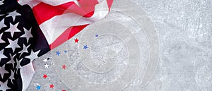 USA American flag and confetti stars on concrete stone background with copy space. Banner template for Presidents day, US Veterans