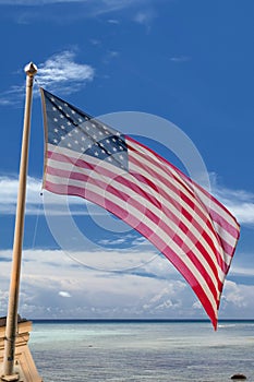 Usa American flag stars and stripes on the tropical sky background