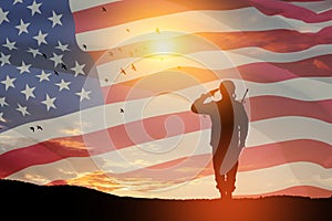 USA army soldier saluting on a background of USA flag. Greeting card for Veterans Day, Memorial Day, Independence Day.