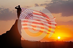 USA army soldier saluting on a background of USA flag. Greeting card for Veterans Day, Memorial Day, Independence Day.