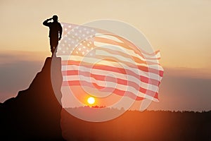 USA army soldier saluting on a background of USA flag. Greeting card for Veterans Day, Memorial Day, Independence Day.