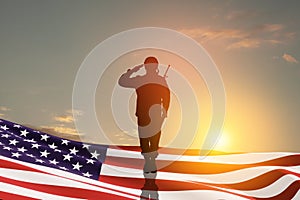 USA army soldier saluting with nation flag. Greeting card for Veterans Day, Memorial Day, Independence Day.