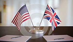 USA and British flags on table. Negotiation between United Kingdom and United states. 3D rendered illustration.
