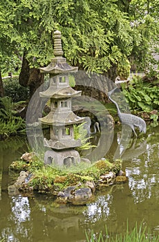 Stone pagoda style statue in pond, Japanese Garden, San Francisco, CA, USA