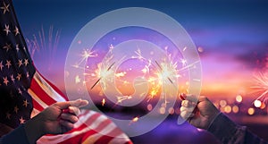 Usa Celebration With Hands Holding Sparklers And American Flag At Sunset photo
