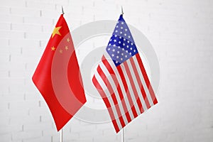 USA and China flags against brick wall. International relations