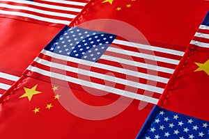 USA and China flags as background, closeup. International relations