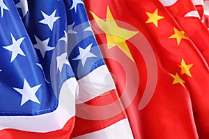 USA and China flags as background, closeup. International relations