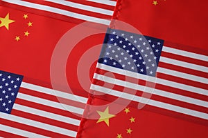 USA and China flags as background, top view. International relations