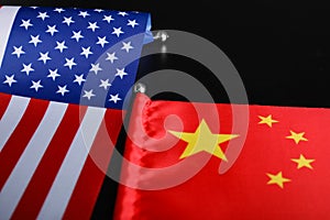 USA and China flags on black background, closeup