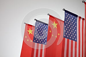 USA and China flags on light background, closeup. International relations