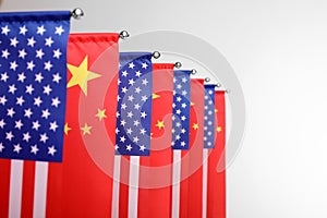 USA and China flags on white background, closeup. International relations