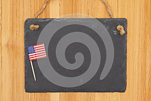 USA concerns blank hanging chalkboard sign with American flag on wood