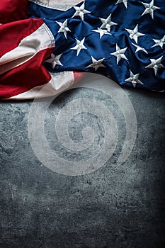 USA flag. American flag. American flag freely lying on concrete background. Close-up Studio shot. Toned Photo