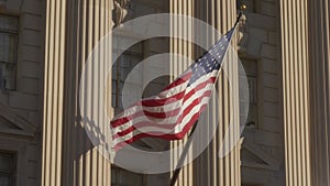 USA flag on facade of US Commerce building in Washington DC