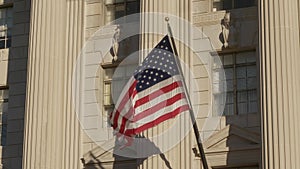 USA flag on facade of US Commerce building in Washington DC