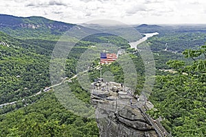 A USA Flag flies on a large boulder on Chimney Rock.