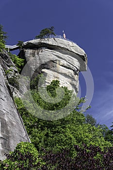 USA flag flies over the boulders of Chimney Rock.