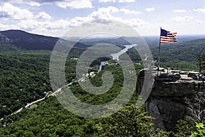 USA flag flies over the boulders of Chimney Rock.