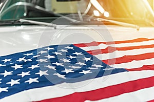 USA flag on the hood of a white car