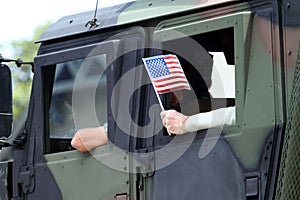 USA Flag Waives From A Military Vehicle photo