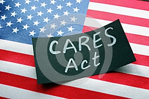 USA flag and word CARES act The Coronavirus Aid, Relief, and Economic Security Act. photo