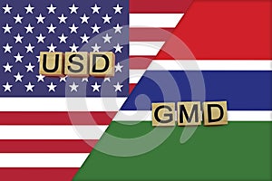 USA and Gambia currencies codes on national flags background