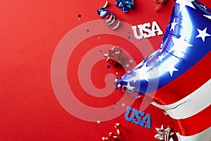 USA Independence Day 4th of July concept. Flat lay composition with balloon and party streamers on red background