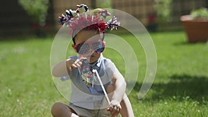 USA independence day concept little boy kid in funny american hairband blowing