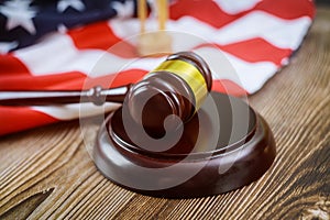 USA lawyers a US legal office with sandglass judge's gavel on American flag wooden table