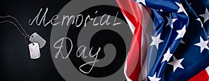 USA Memorial Day concept. American flag and dog tags on black background. Handwritten lettering on chalkboard