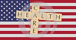 USA News Concept: Letter Tiles Health Care On US Flag, 3d illustration